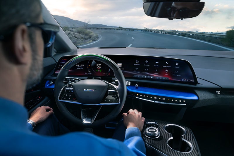 Front View of the 2026 OPTIQ-V Driving Through the Dusk Utilizing its Headlights | Randy Marion Cadillac Jacksonville in Jacksonville FL